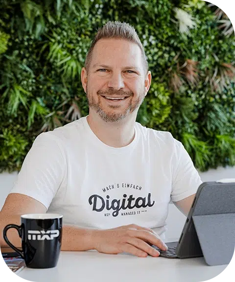 MXP GmbH Geschäftsführer Roland Berger mit Tablet und Kaffeetasse im modernen Büro